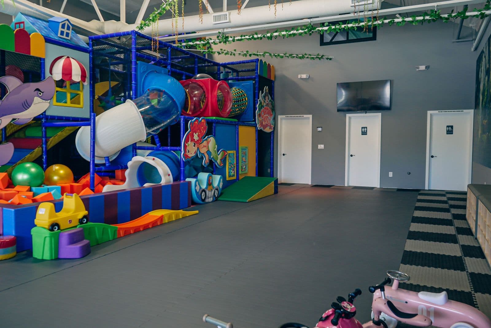 The party room with the climbing structure and slides behind it