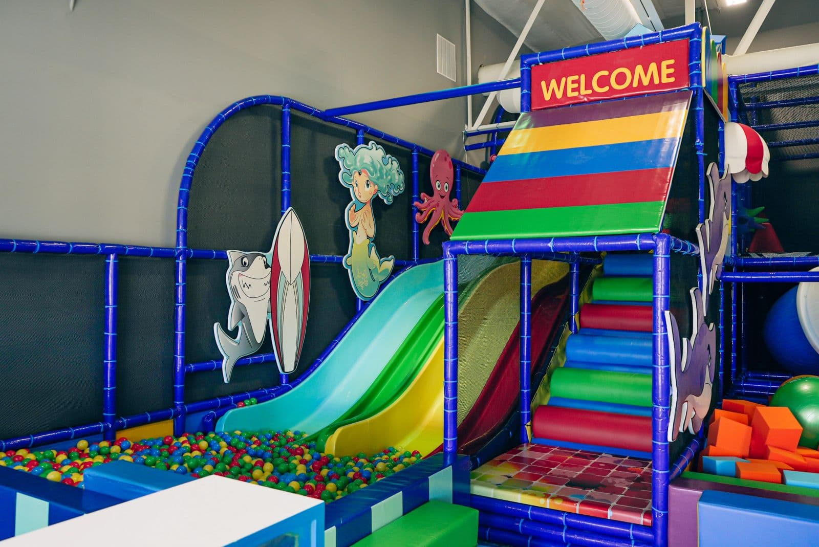 The welcome sign over the little slide and the soft blocks